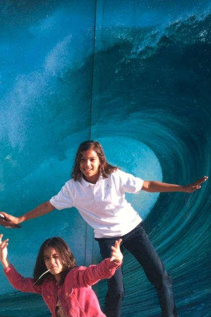 Emma and Camila pretending to be surfing 