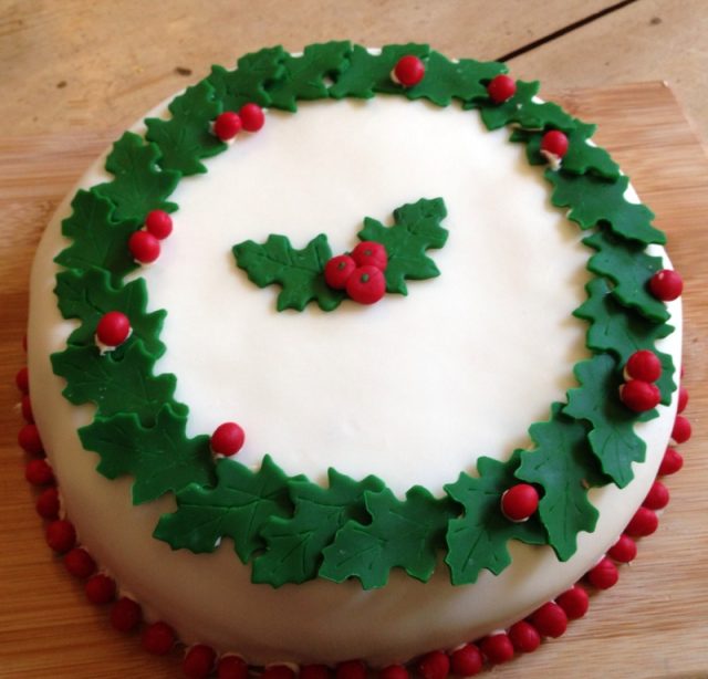 A cake for Christmas with green and red decorations