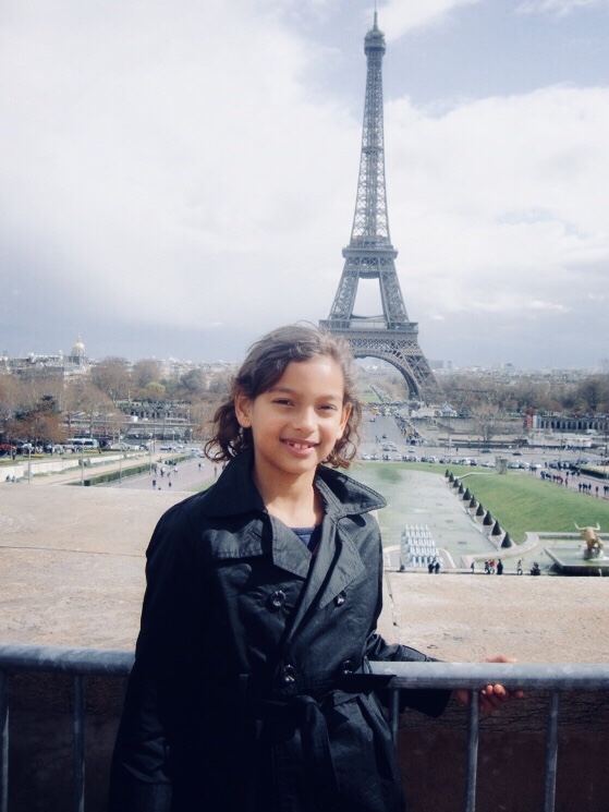 Camila with the Eiffel Tower in the background