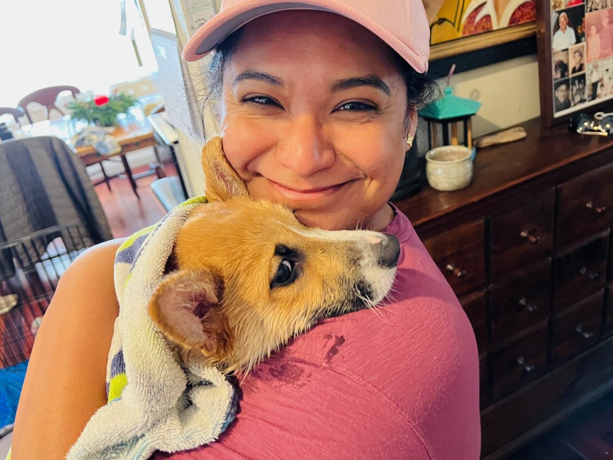 Chando holding her corgi Mayday after bathing him