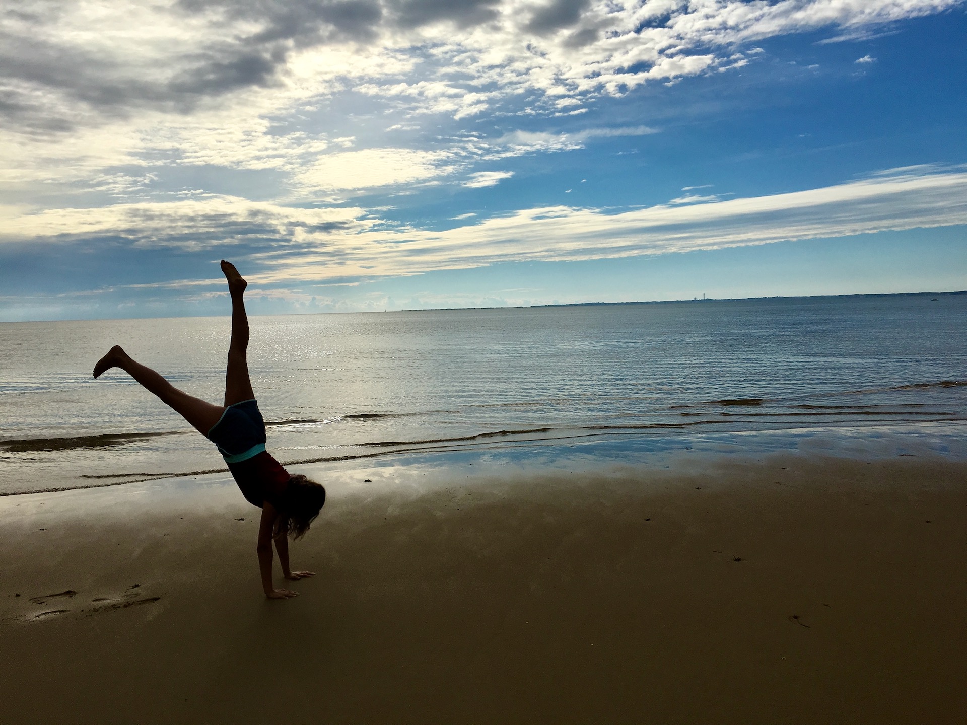 Kid doing a cartwheel at the beach in Truro, MA
