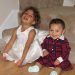 Two little girls seating and smiling